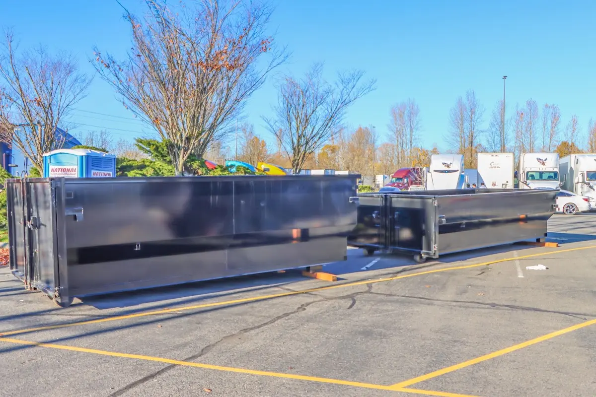 Professional dumpster rental service with roll-off container on residential driveway in Phoenix